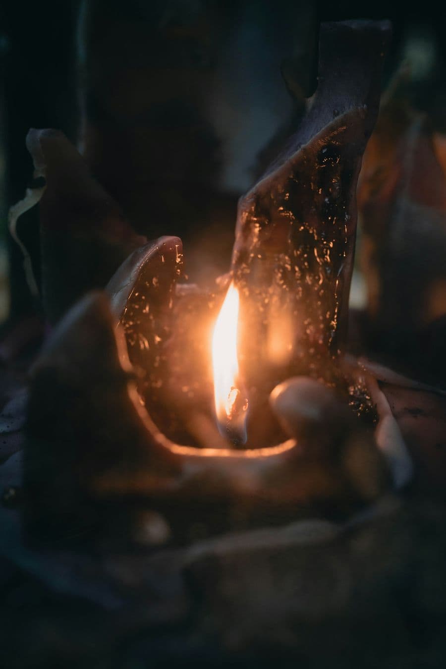 A burning candle with melted wax showing common burn mistakes