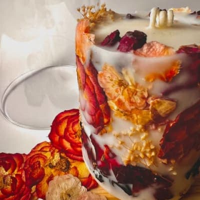 Pressed botanicals arranged inside a handcrafted Candera candle